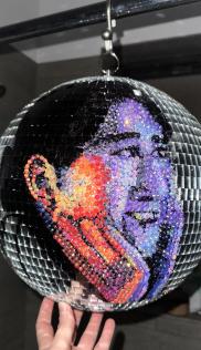 Custom rhinestone-encrusted disco ball with a person's face depicted in mosaic